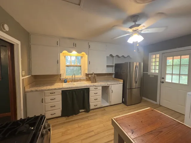 a kitchen with a stove a sink and a refrigerator