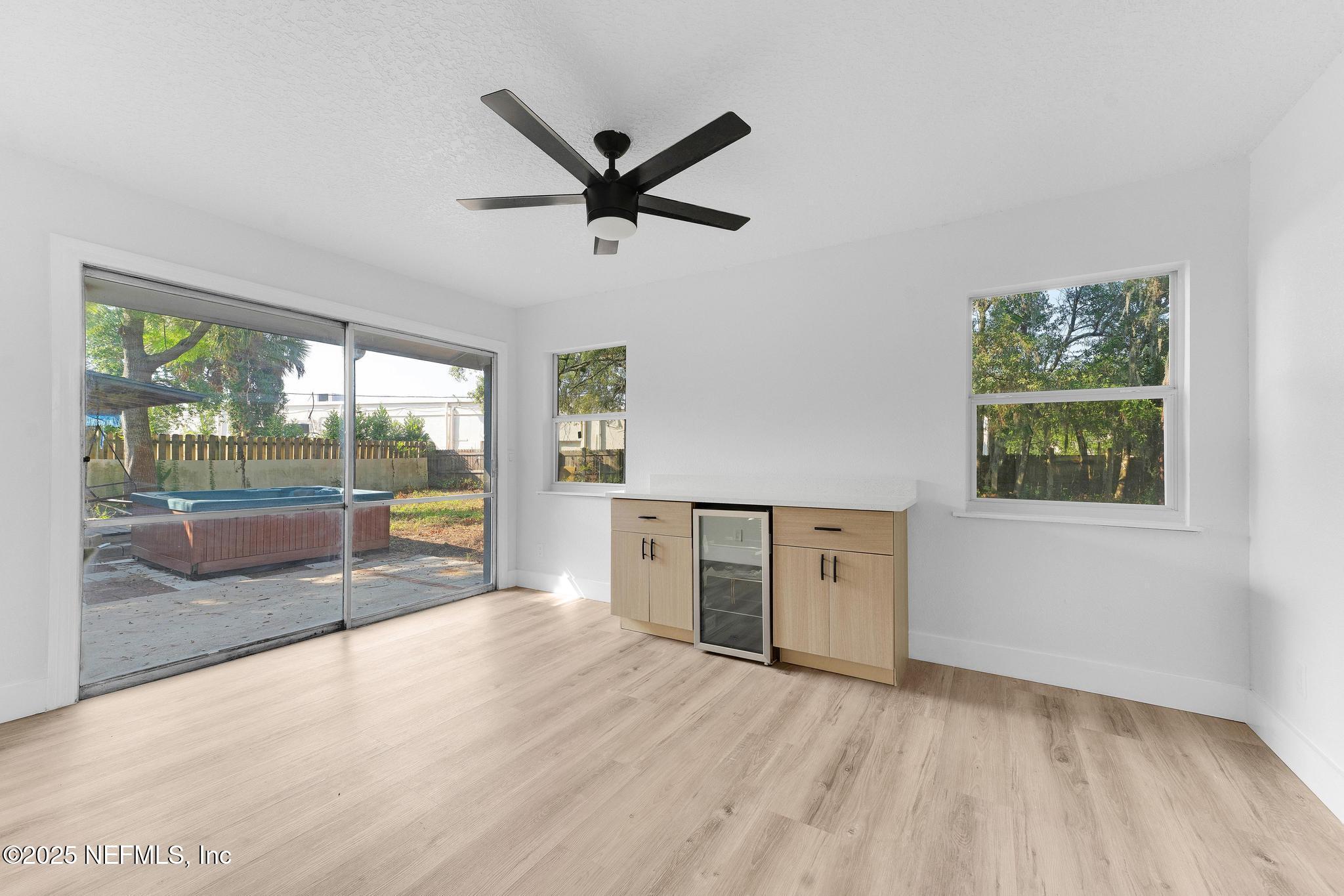 6537 Simca Drive Jacksonville, FL 32277 - Photo 11 of 25 wooden floor in an empty room with a window