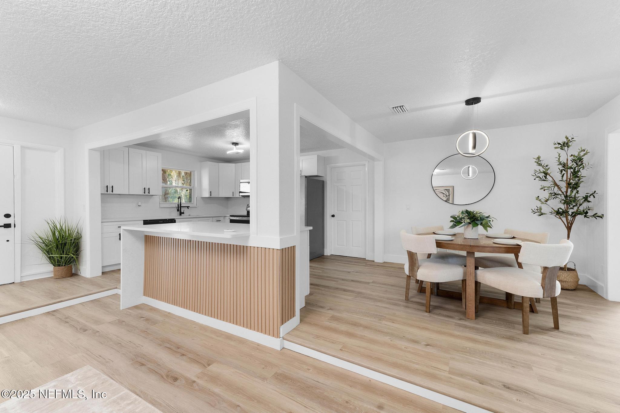 6537 Simca Drive Jacksonville, FL 32277 - Photo 13 of 25 a view of kitchen with sink dining table and chairs