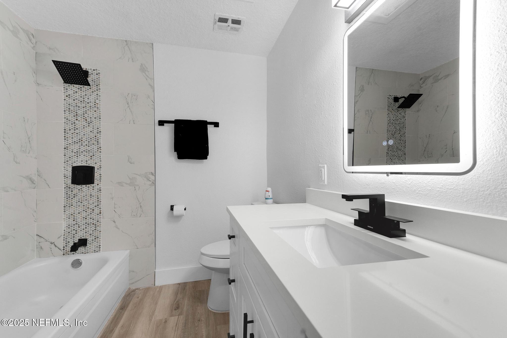 6537 Simca Drive Jacksonville, FL 32277 - Photo 15 of 25 a bathroom with a sink a toilet and a bathtub