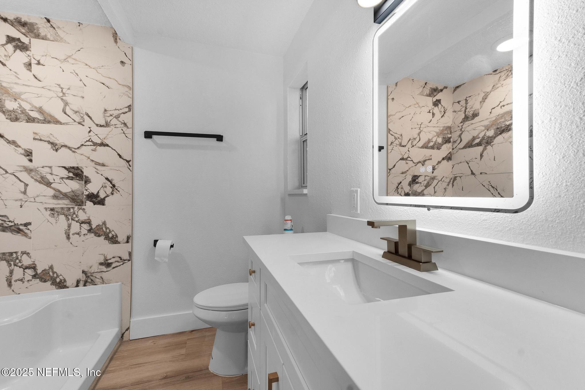 6537 Simca Drive Jacksonville, FL 32277 - Photo 21 of 25 a bathroom with a sink toilet and a mirror