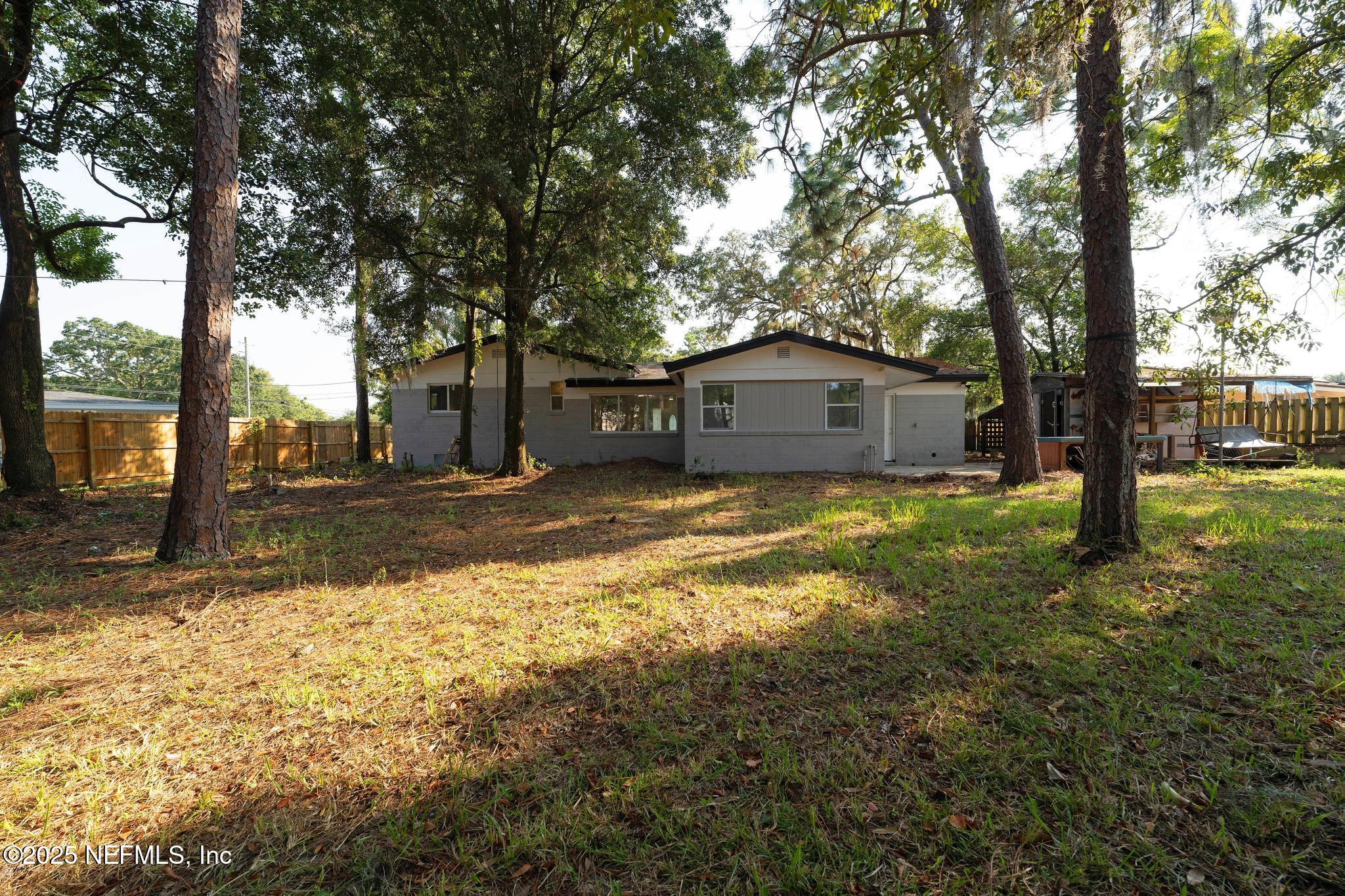 6537 Simca Drive Jacksonville, FL 32277 - Photo 24 of 25 a front view of a house with a yard and large tree