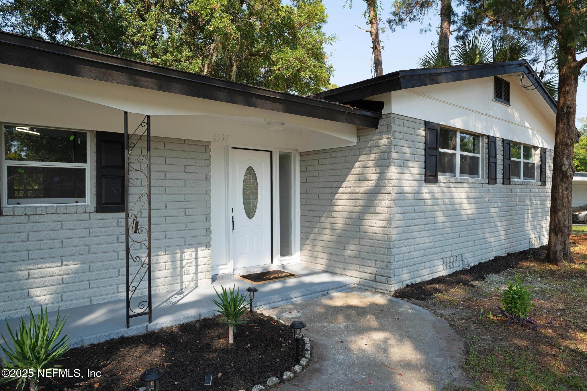 6537 Simca Drive Jacksonville, FL 32277 - Photo 3 of 25 a view of a small house with yard