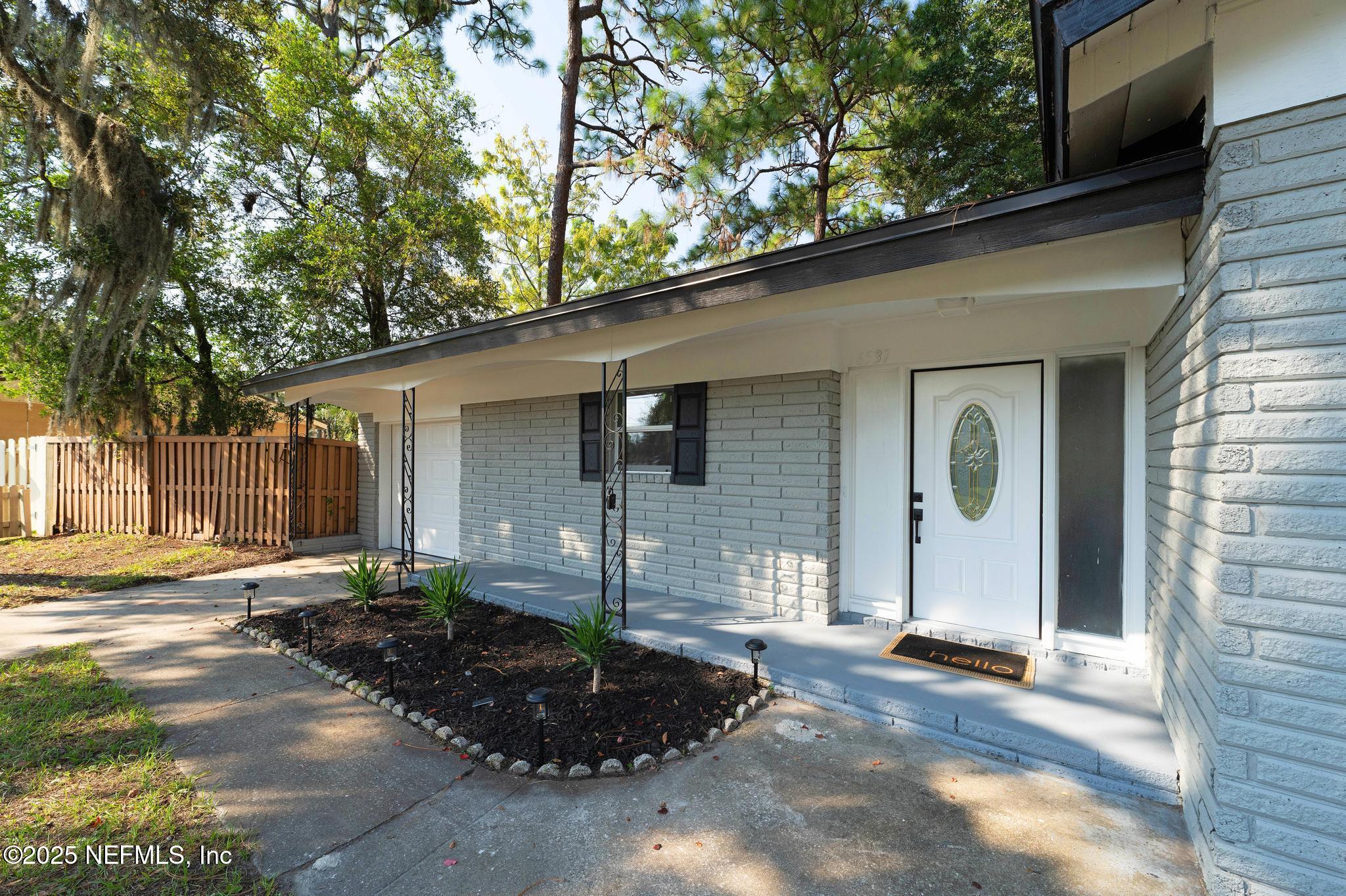 6537 Simca Drive Jacksonville, FL 32277 - Photo 4 of 25 a front view of a house with garden