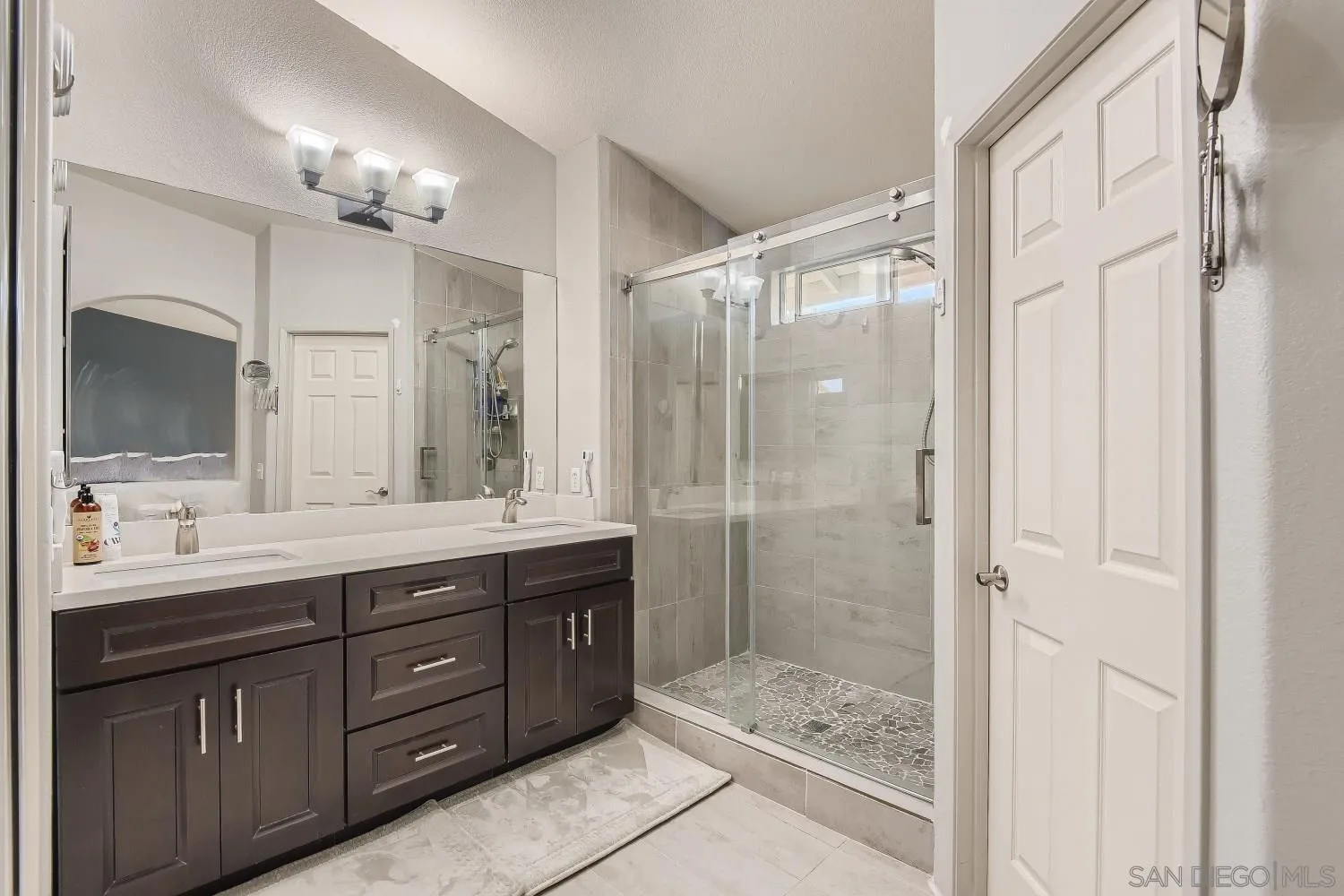 418 Helix Way Oceanside, CA 92057 - Photo 14 of 22 a bathroom with a double vanity sink mirror and shower