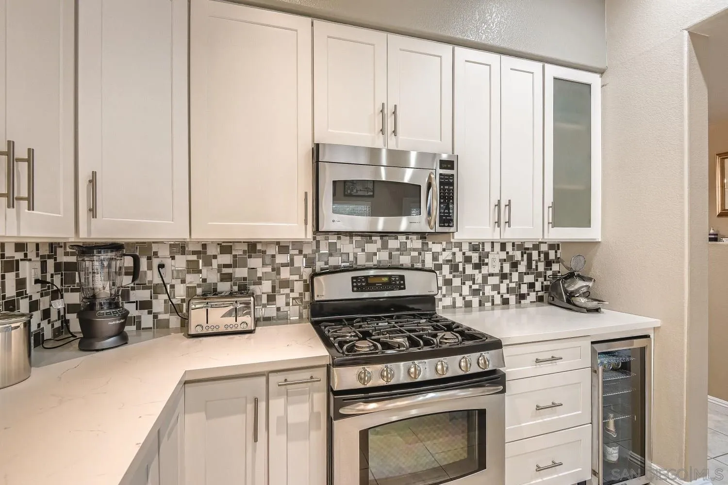 418 Helix Way Oceanside, CA 92057 - Photo 7 of 22 a kitchen with granite countertop a stove and a sink