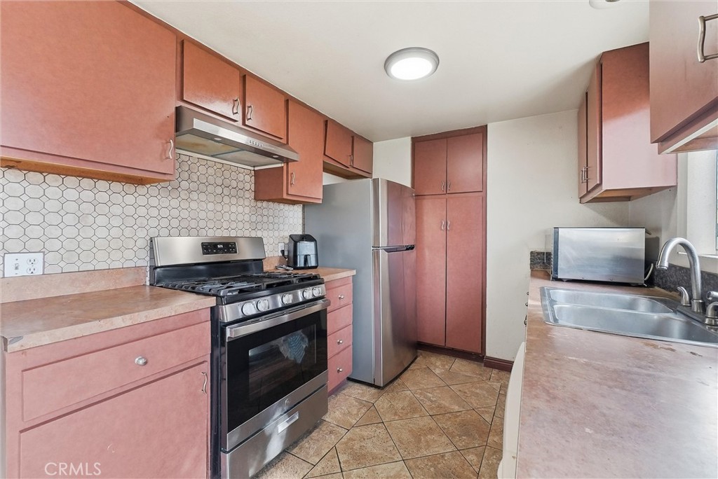 16716 East Renwick Road Azusa, CA 91702 - Photo 12 of 31 a kitchen with stainless steel appliances granite countertop a stove a refrigerator and a sink