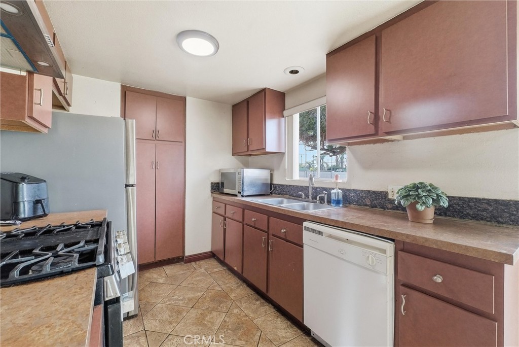 16716 East Renwick Road Azusa, CA 91702 - Photo 13 of 31 a kitchen with stainless steel appliances granite countertop a sink stove and refrigerator