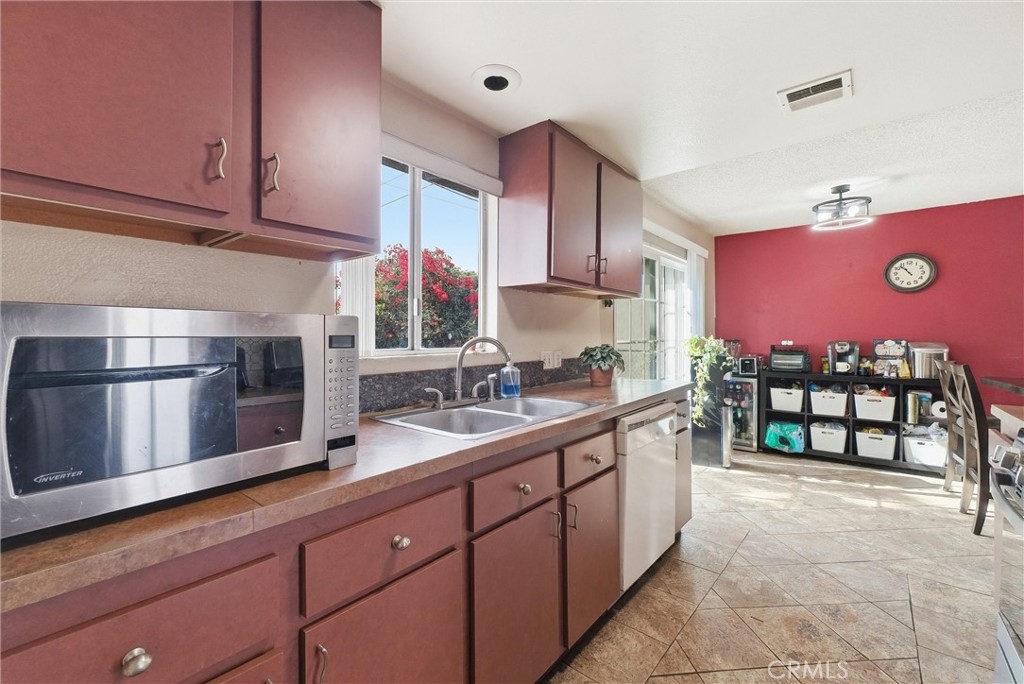 16716 East Renwick Road Azusa, CA 91702 - Photo 14 of 31 a kitchen with stainless steel appliances a sink cabinets and wooden floor