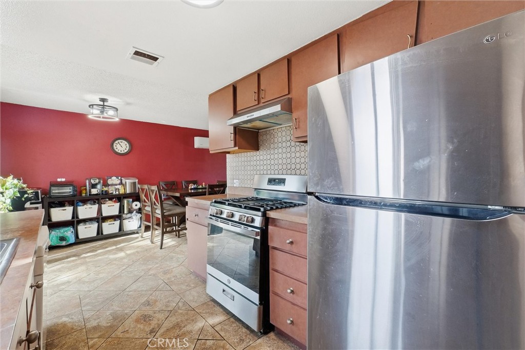 16716 East Renwick Road Azusa, CA 91702 - Photo 15 of 31 a kitchen with stainless steel appliances granite countertop a refrigerator stove and sink