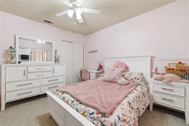 a bedroom with a bed and a dresser