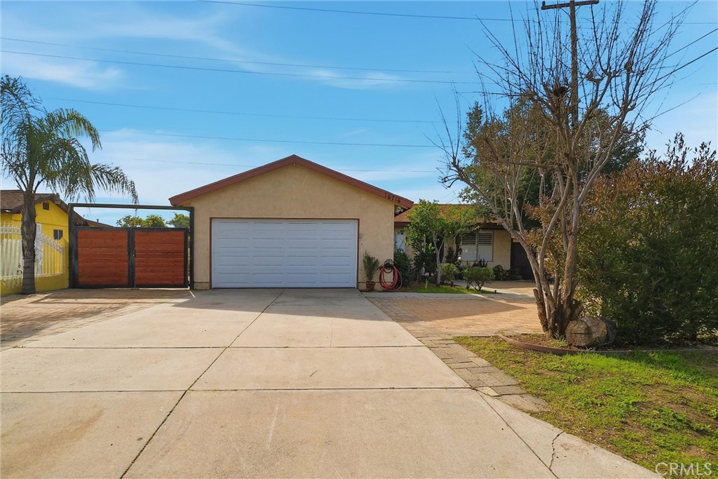 16716 East Renwick Road Azusa, CA 91702 - Photo 4 of 31 a front view of a house with a yard and garage