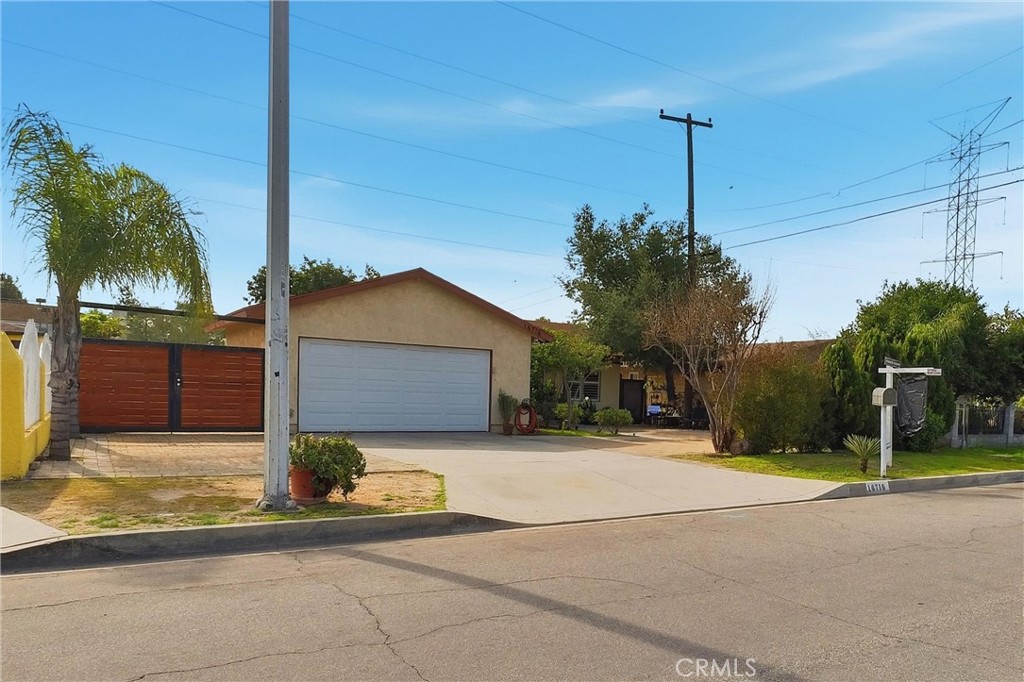 16716 East Renwick Road Azusa, CA 91702 - Photo 5 of 31 a view of a house with palm trees and a small yard