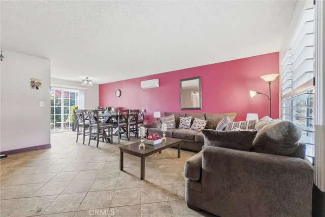 a living room with furniture and dining area