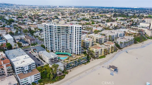 an aerial view of a house with a yard and wooden fence
