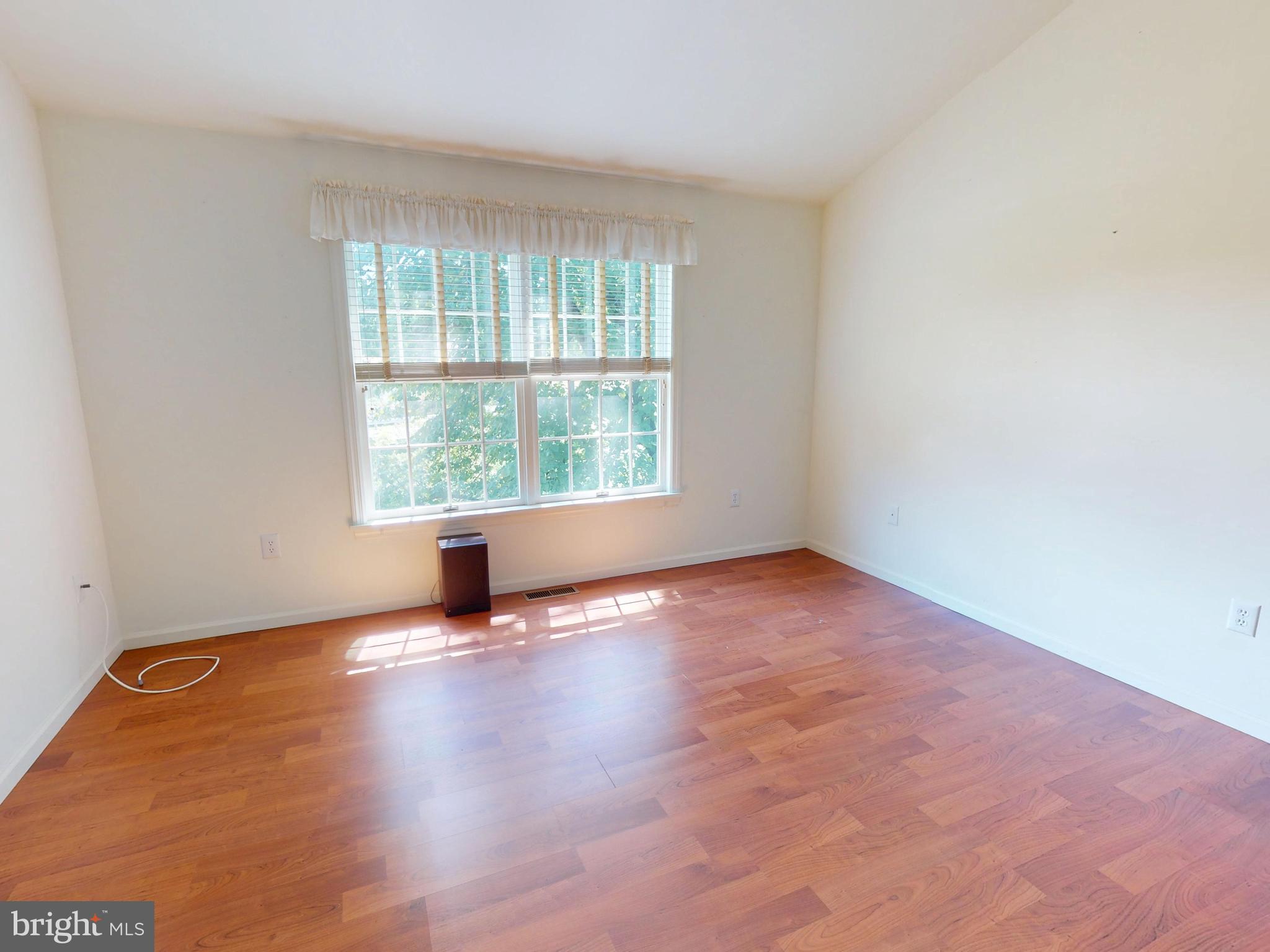 128 Colonial Court State College, PA 16801 - Photo 18 of 39 an empty room with wooden floor and windows