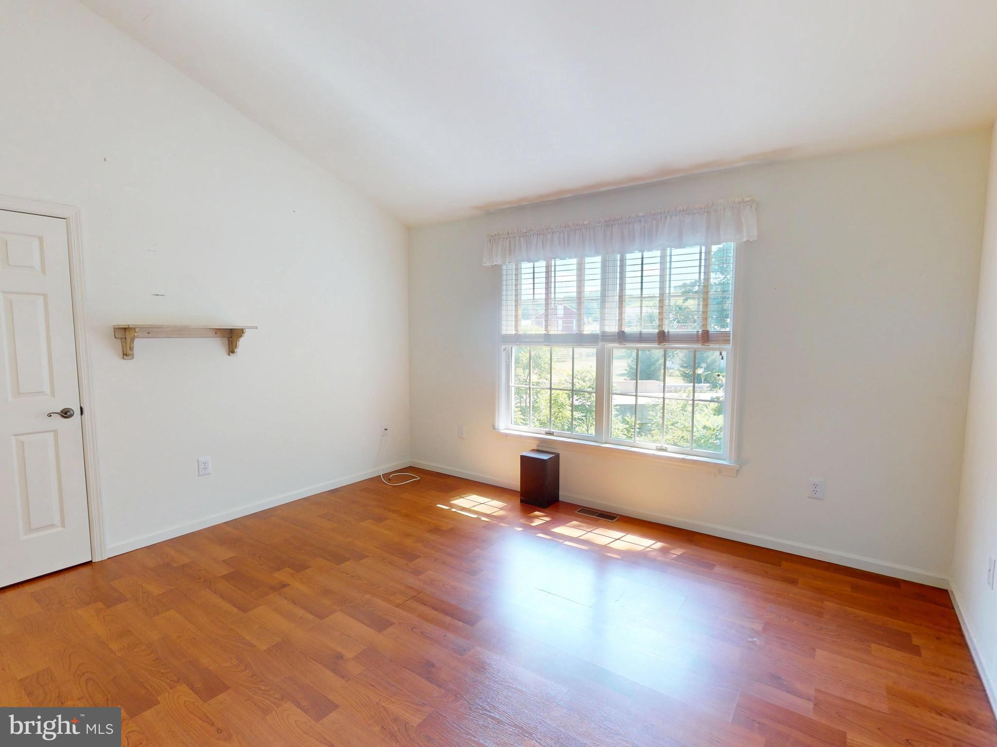 128 Colonial Court State College, PA 16801 - Photo 19 of 39 an empty room with wooden floor and windows