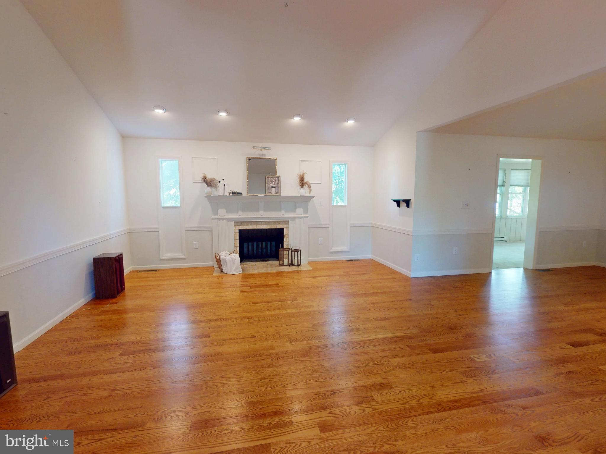 128 Colonial Court State College, PA 16801 - Photo 2 of 39 a view of empty room with wooden floor and fireplace
