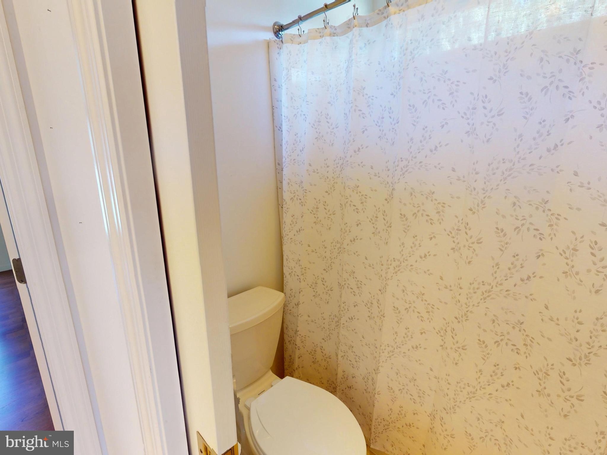 128 Colonial Court State College, PA 16801 - Photo 21 of 39 a white toilet sitting next to a shower curtain