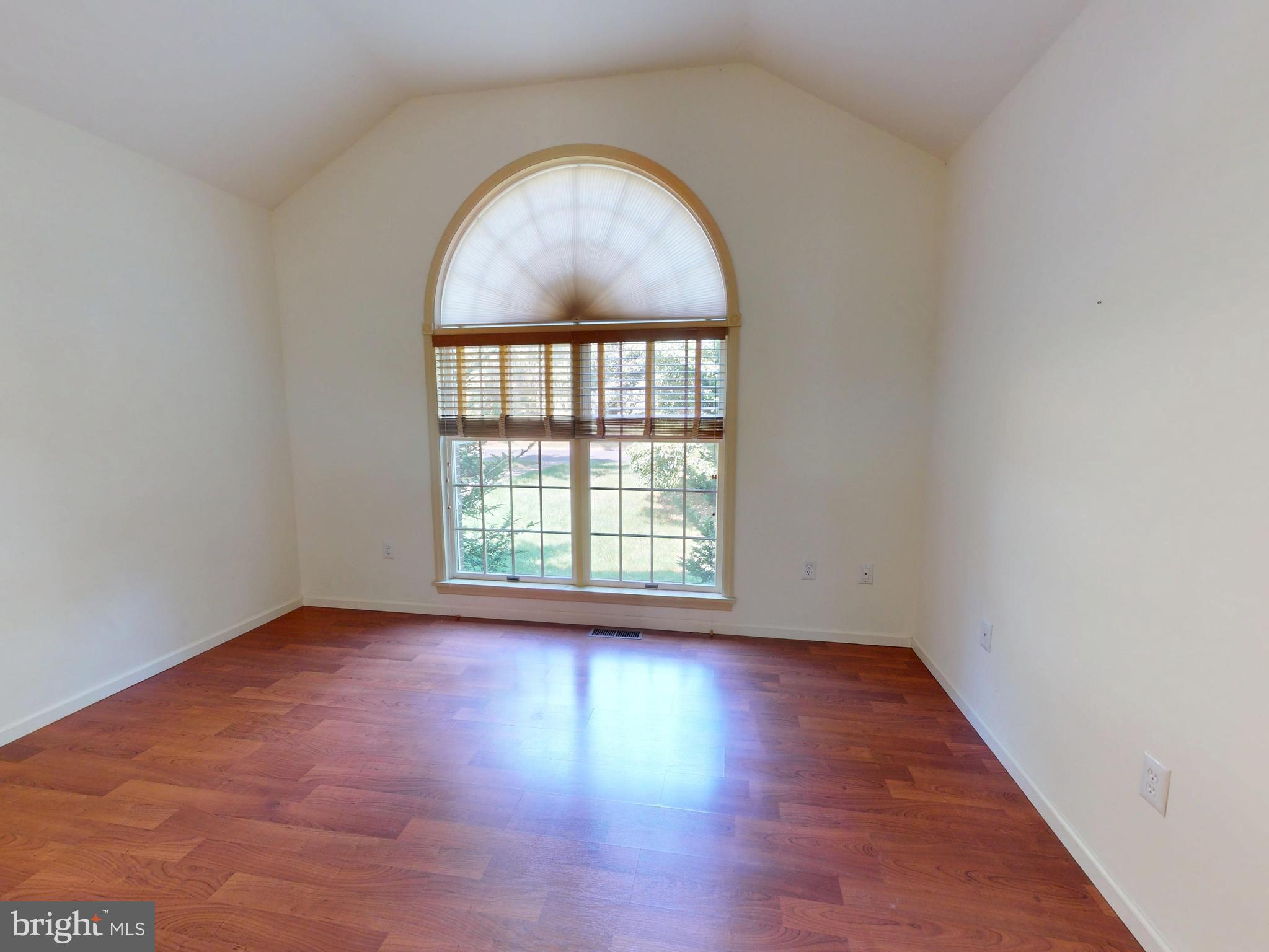 128 Colonial Court State College, PA 16801 - Photo 22 of 39 an empty room with wooden floor and a window