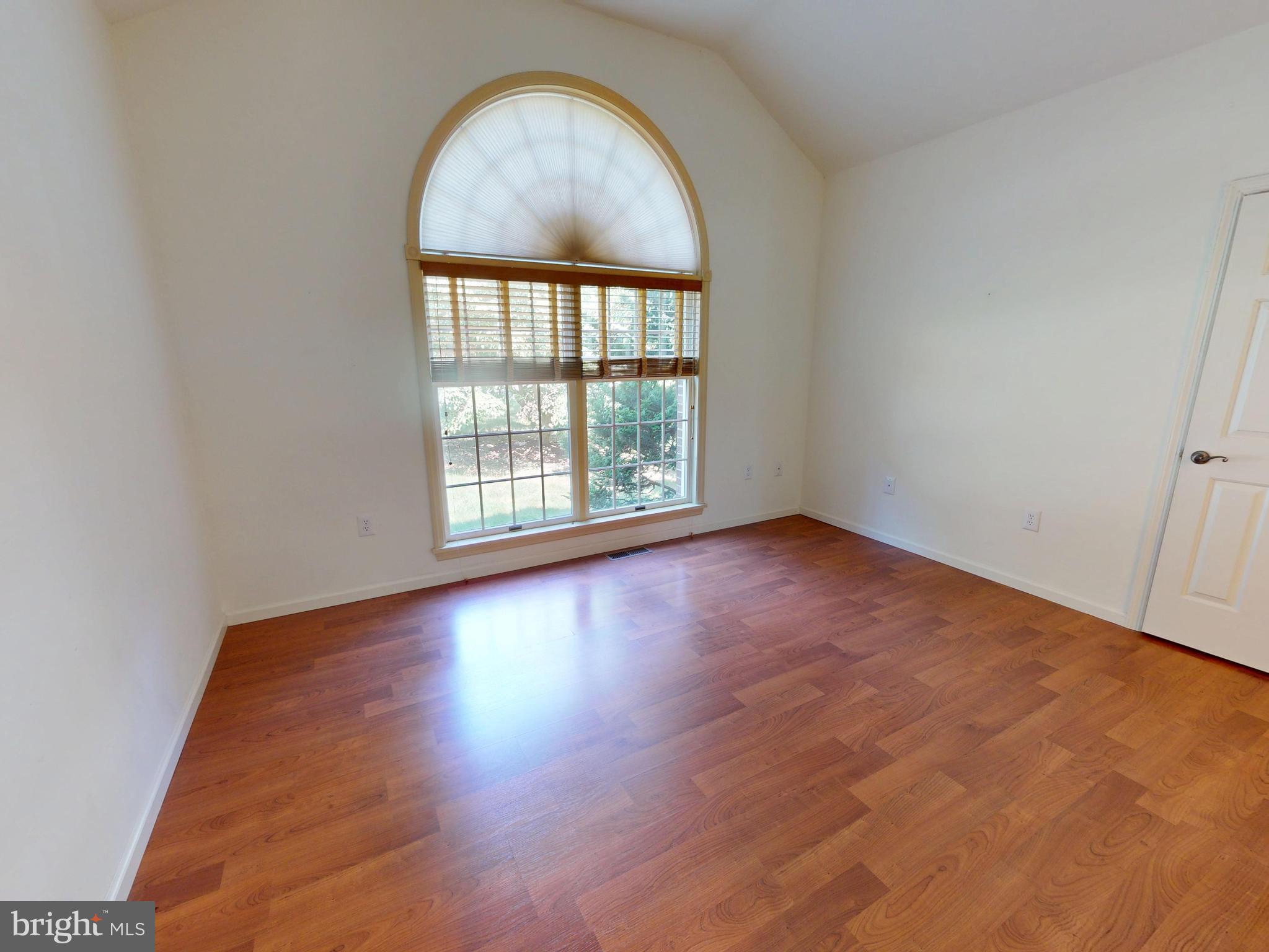 128 Colonial Court State College, PA 16801 - Photo 23 of 39 an empty room with wooden floor and windows