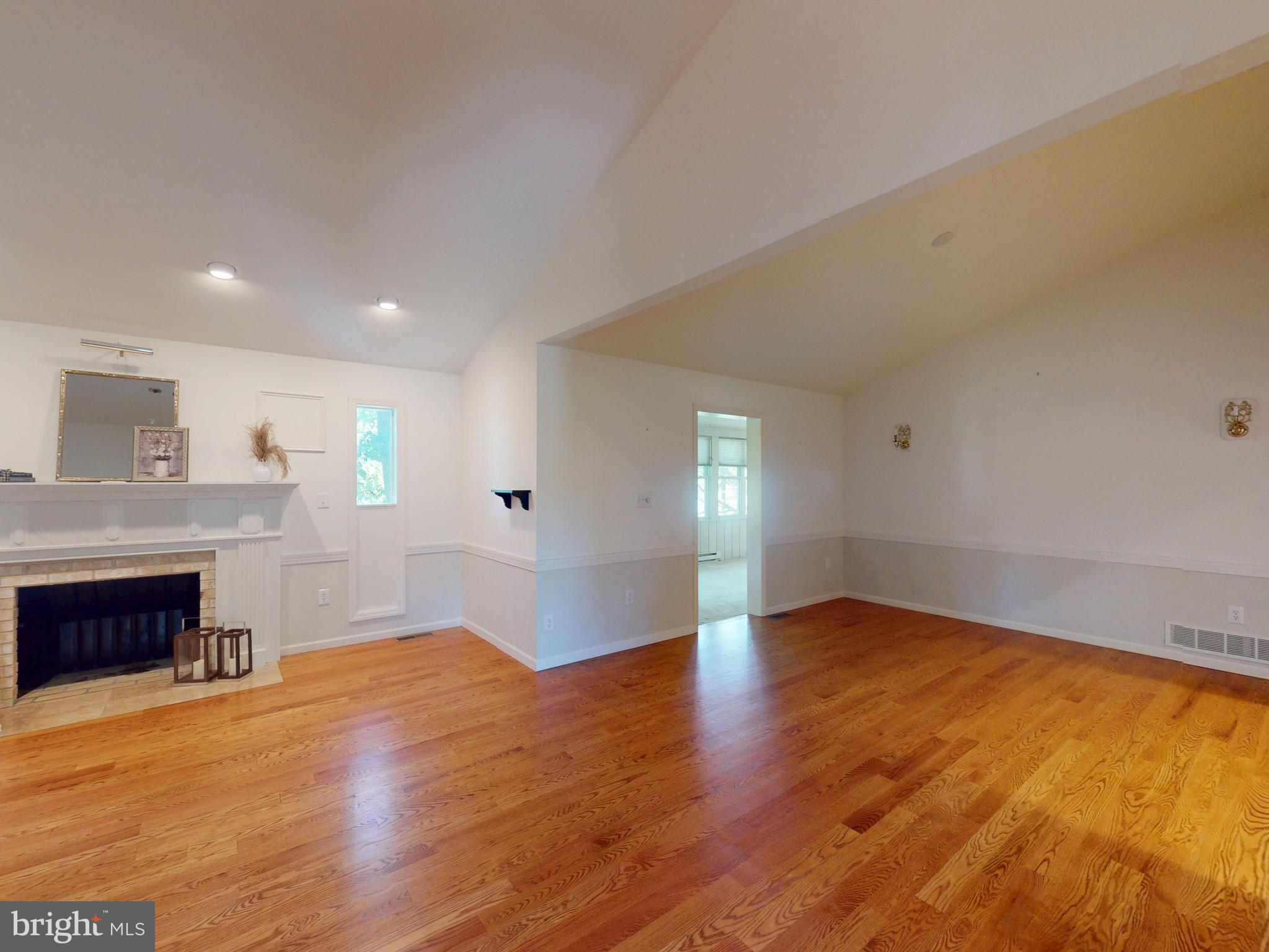 128 Colonial Court State College, PA 16801 - Photo 4 of 39 an empty room with wooden floor and fireplace