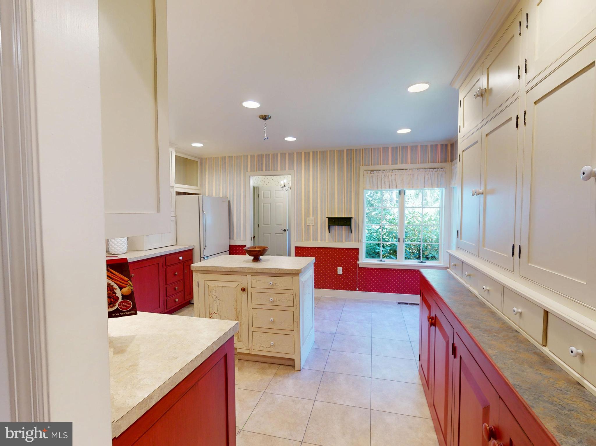 128 Colonial Court State College, PA 16801 - Photo 7 of 39 a large kitchen with a large counter top a sink a stove and wooden floors