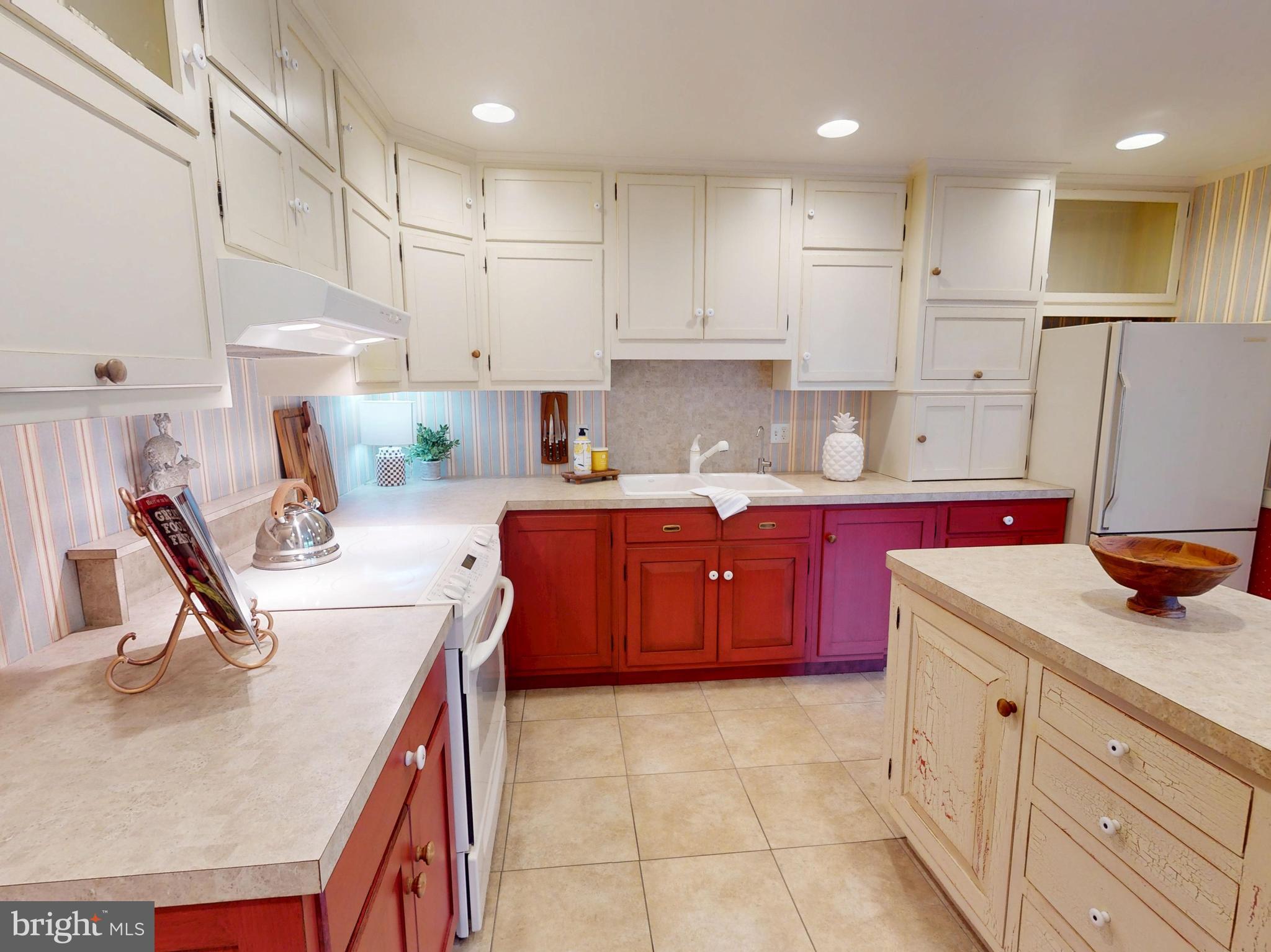 128 Colonial Court State College, PA 16801 - Photo 8 of 39 a kitchen with kitchen island granite countertop a sink stove and refrigerator