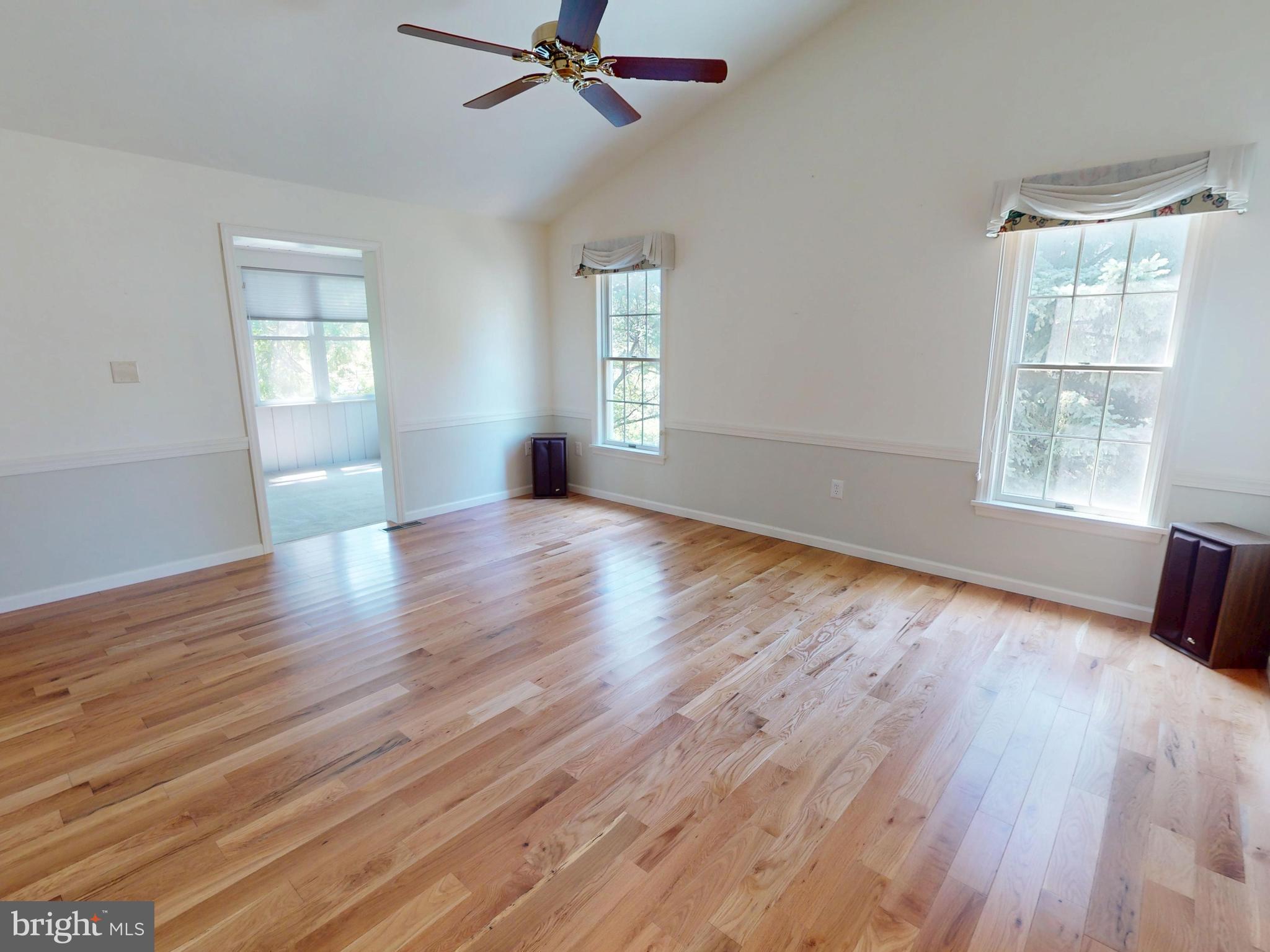 128 Colonial Court State College, PA 16801 - Photo 10 of 39 a view of an empty room with wooden floor and a window