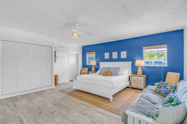 a spacious bedroom with a bed and a couch