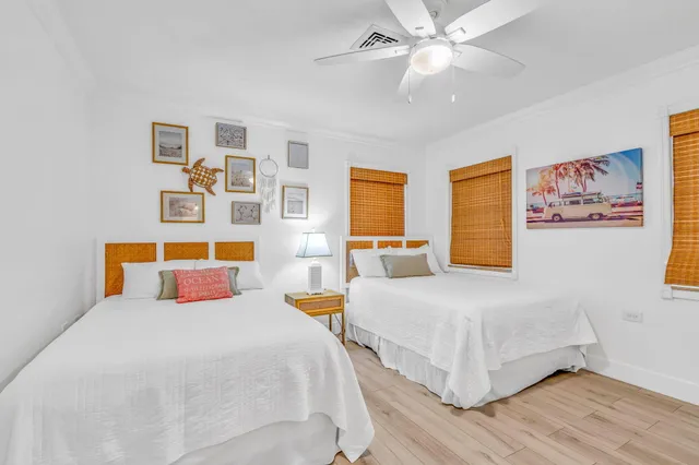 a bedroom with two beds and a chandelier