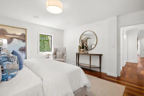 a bedroom with a large bed and a window