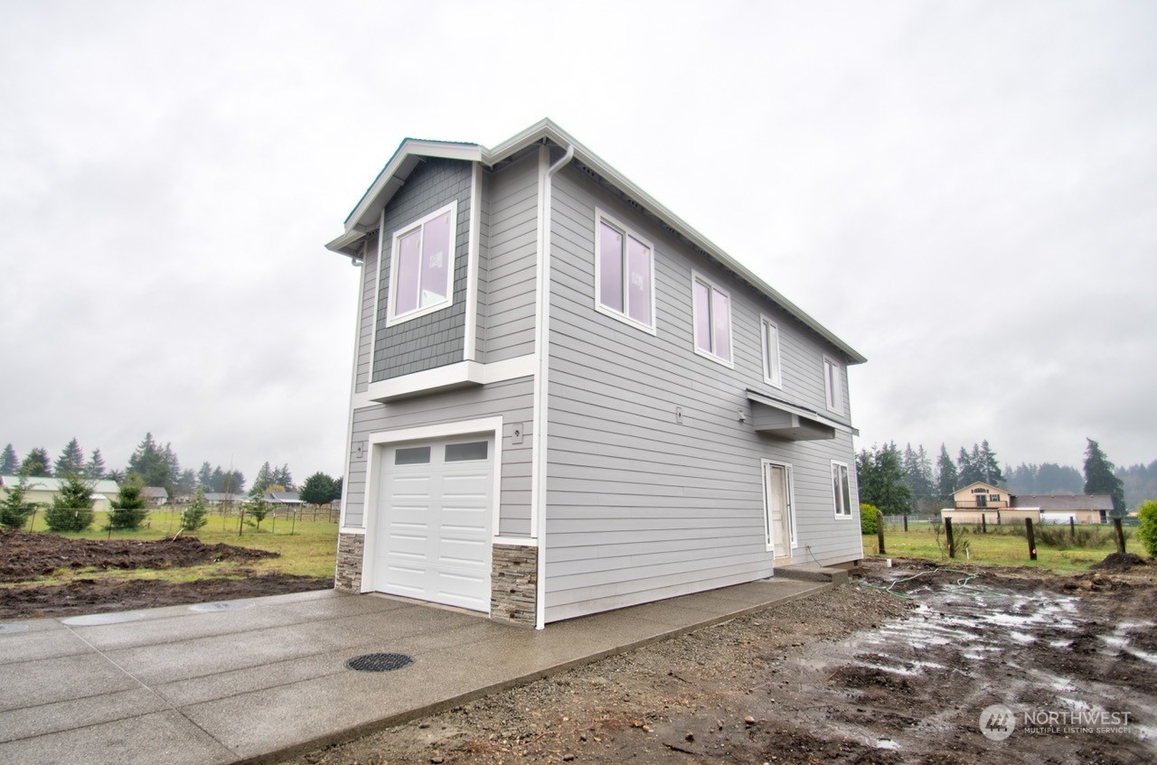 17942 Jordan Street Southwest Rochester, WA 98579 - Photo 1 of 13 a backyard of a house with a yard
