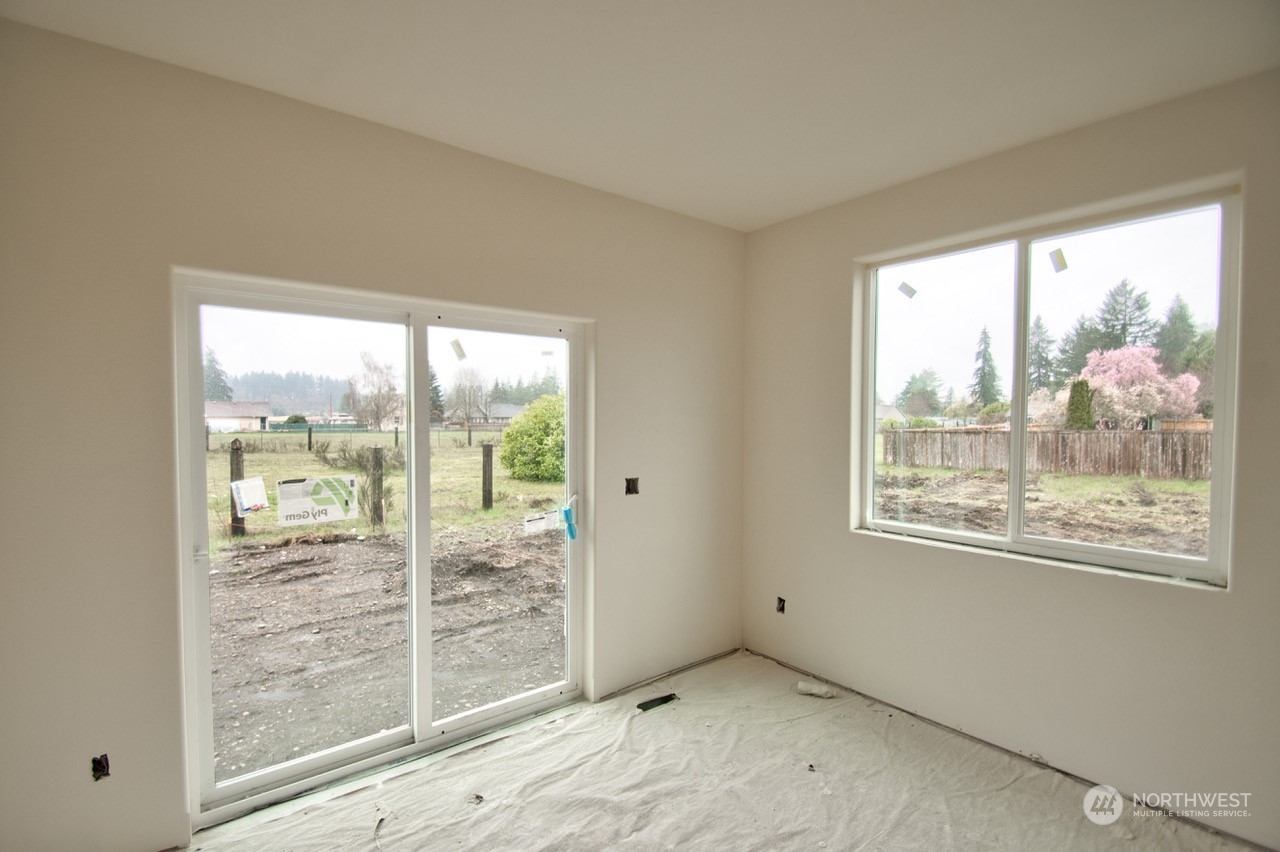 17942 Jordan Street Southwest Rochester, WA 98579 - Photo 8 of 13 a view of an empty room with wooden floor and a window