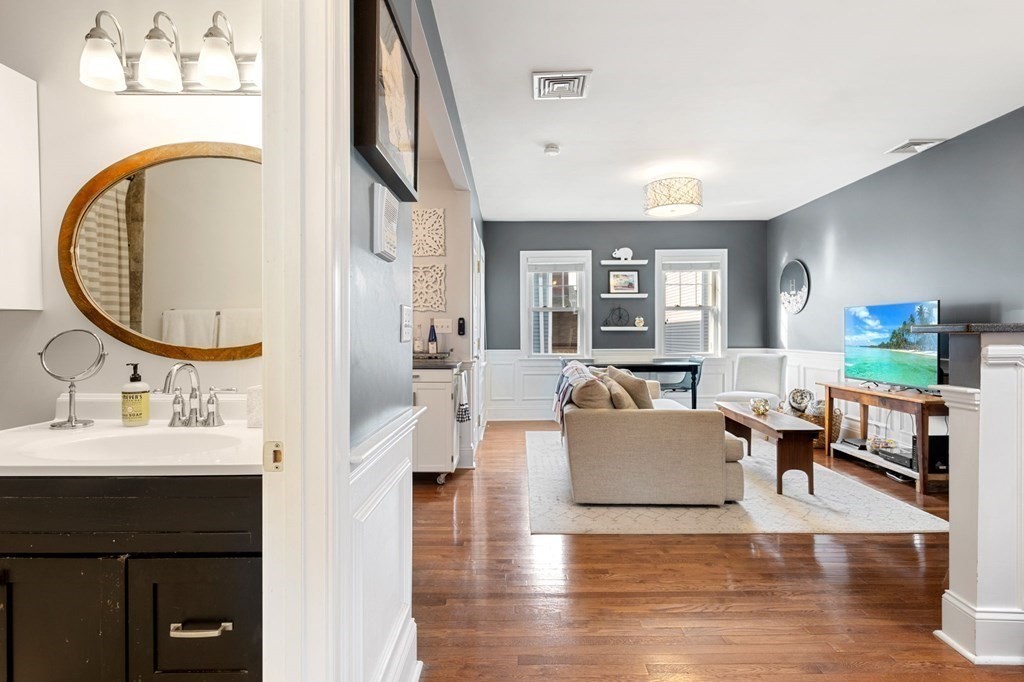 293 West 2nd Street, Unit 3 Boston, MA 02127 - Photo 12 of 25 a living room with fireplace furniture and a wooden floor
