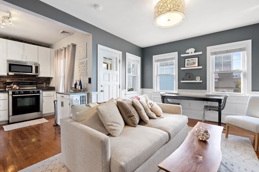 293 West 2nd Street, Unit 3 Boston, MA 02127 - Photo 2 of 25 a living room with furniture and a fireplace