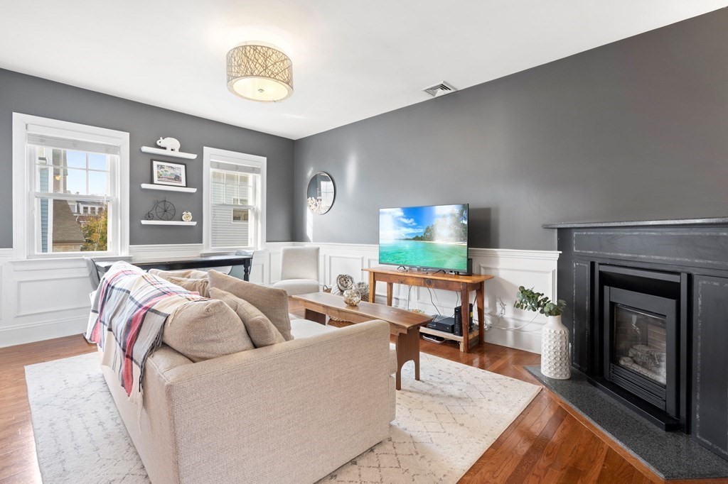 293 West 2nd Street, Unit 3 Boston, MA 02127 - Photo 3 of 25 a living room with furniture and a fireplace