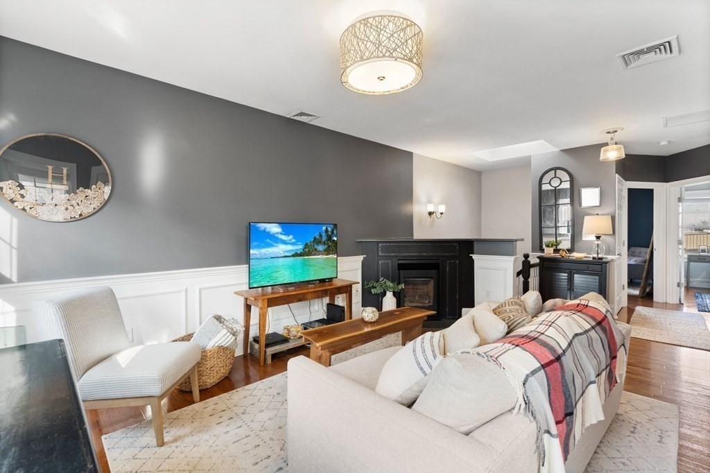 293 West 2nd Street, Unit 3 Boston, MA 02127 - Photo 6 of 25 a living room with fireplace furniture and a flat screen tv