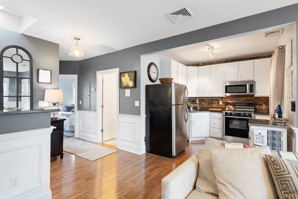 293 West 2nd Street, Unit 3 Boston, MA 02127 - Photo 10 of 25 a kitchen with stainless steel appliances a refrigerator stove microwave and sink