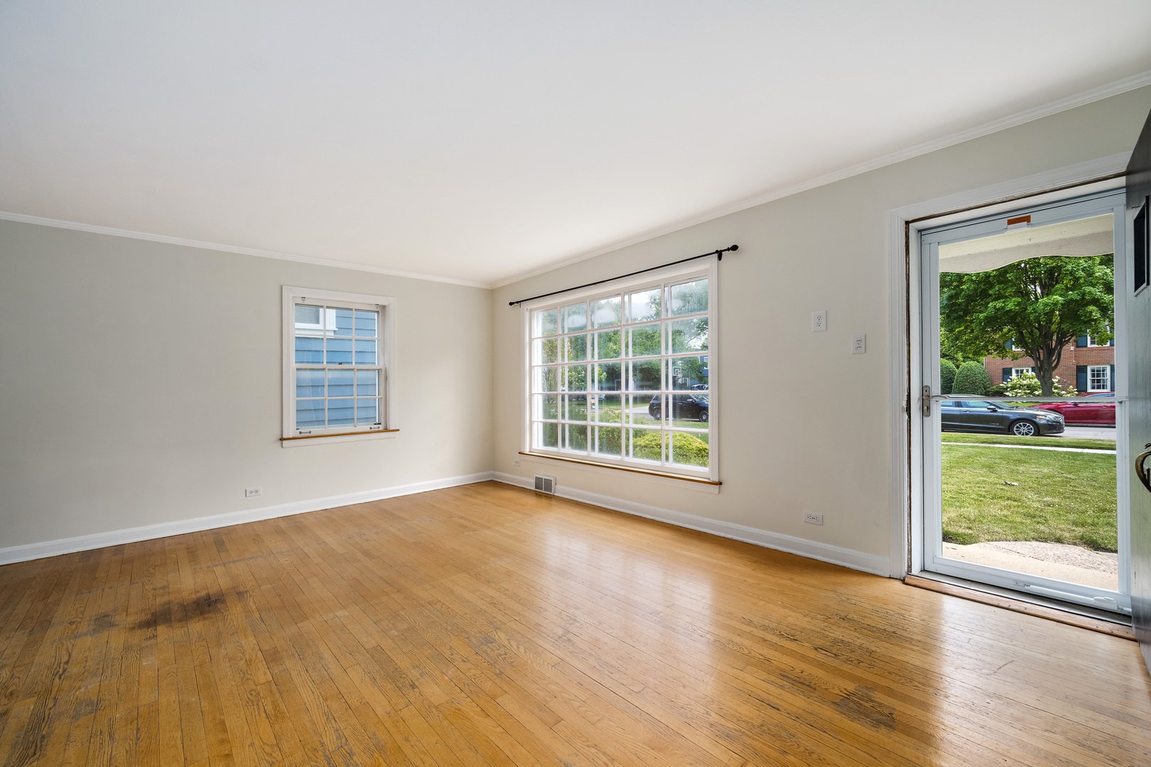 2104 Linneman Street Glenview, IL 60025 - Photo 3 of 19 a view of an empty room with wooden floor and a window