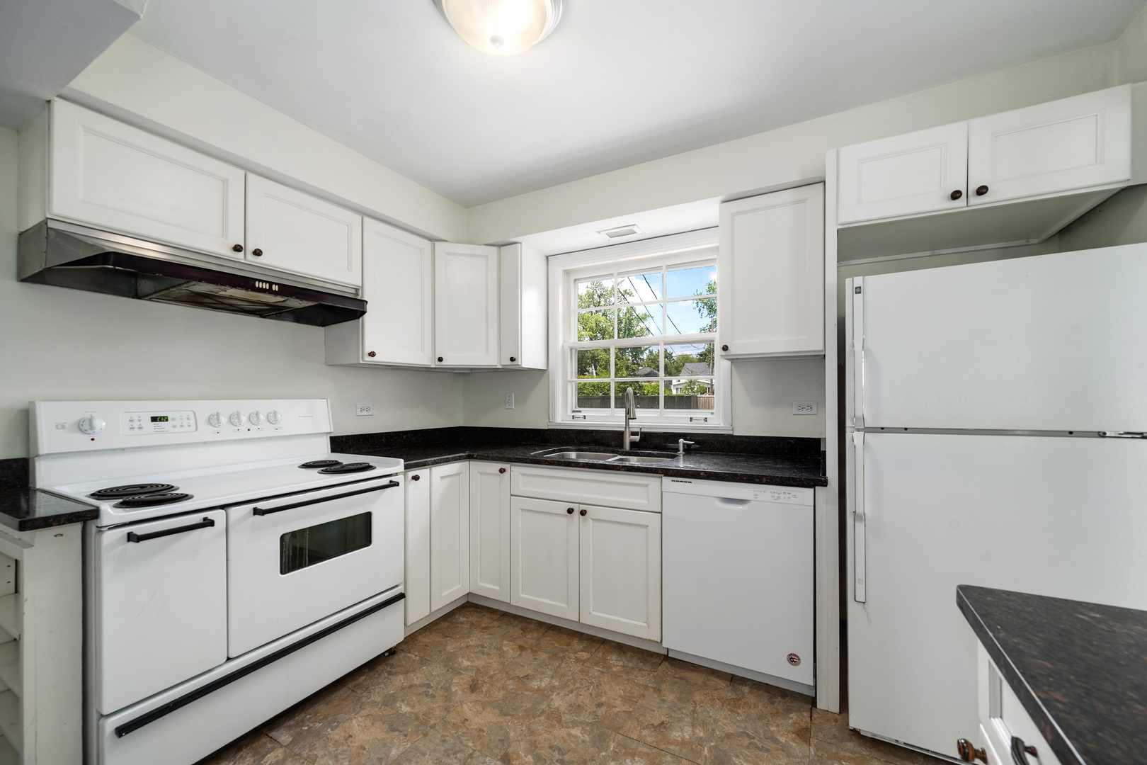 2104 Linneman Street Glenview, IL 60025 - Photo 6 of 19 a kitchen with granite countertop white cabinets and white appliances