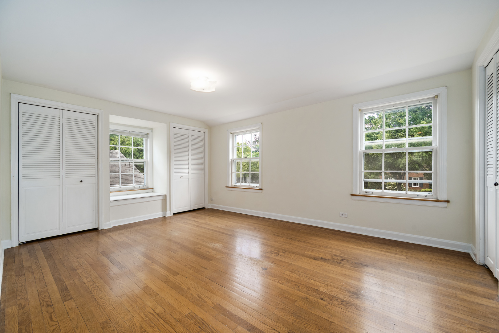 2104 Linneman Street Glenview, IL 60025 - Photo 9 of 19 a view of an empty room with wooden floor and windows