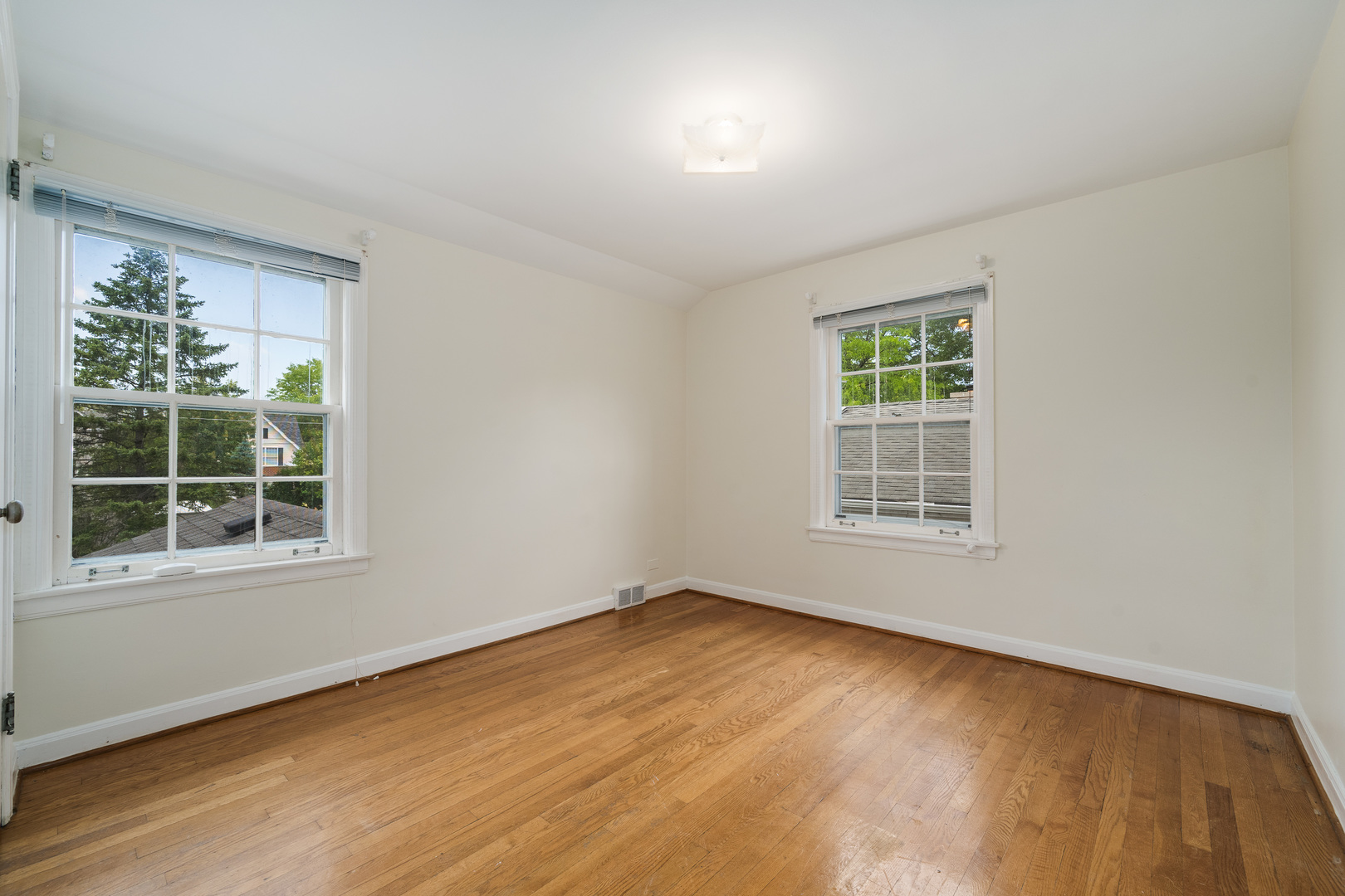 2104 Linneman Street Glenview, IL 60025 - Photo 10 of 19 an empty room with wooden floor and windows