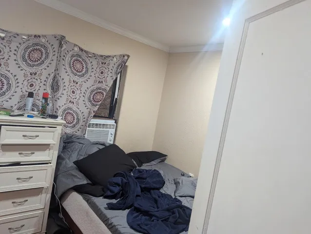 a view of a hallway with cabinets