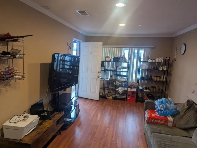 a living room with furniture and a book shelf