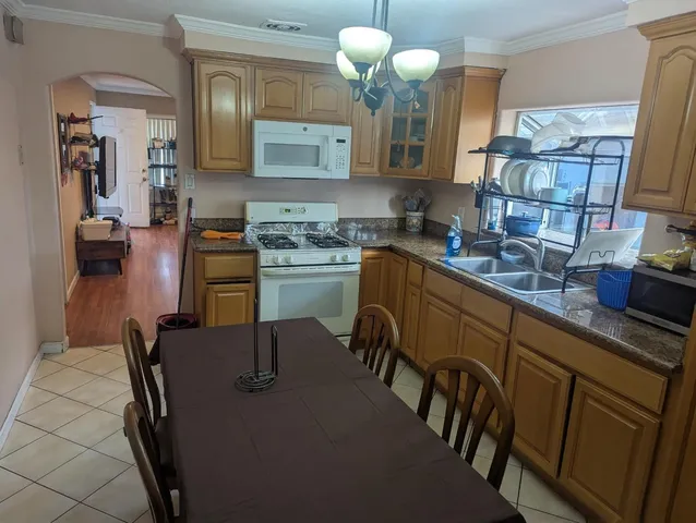 a kitchen with cabinets a sink and appliances