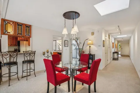 a view of a dining room with furniture and chandelier