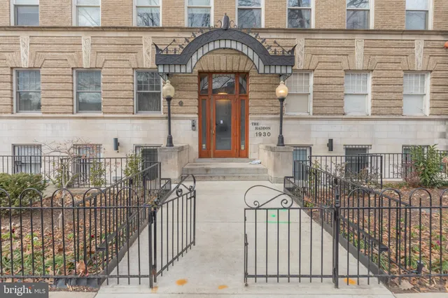 a view of a brick house with large windows