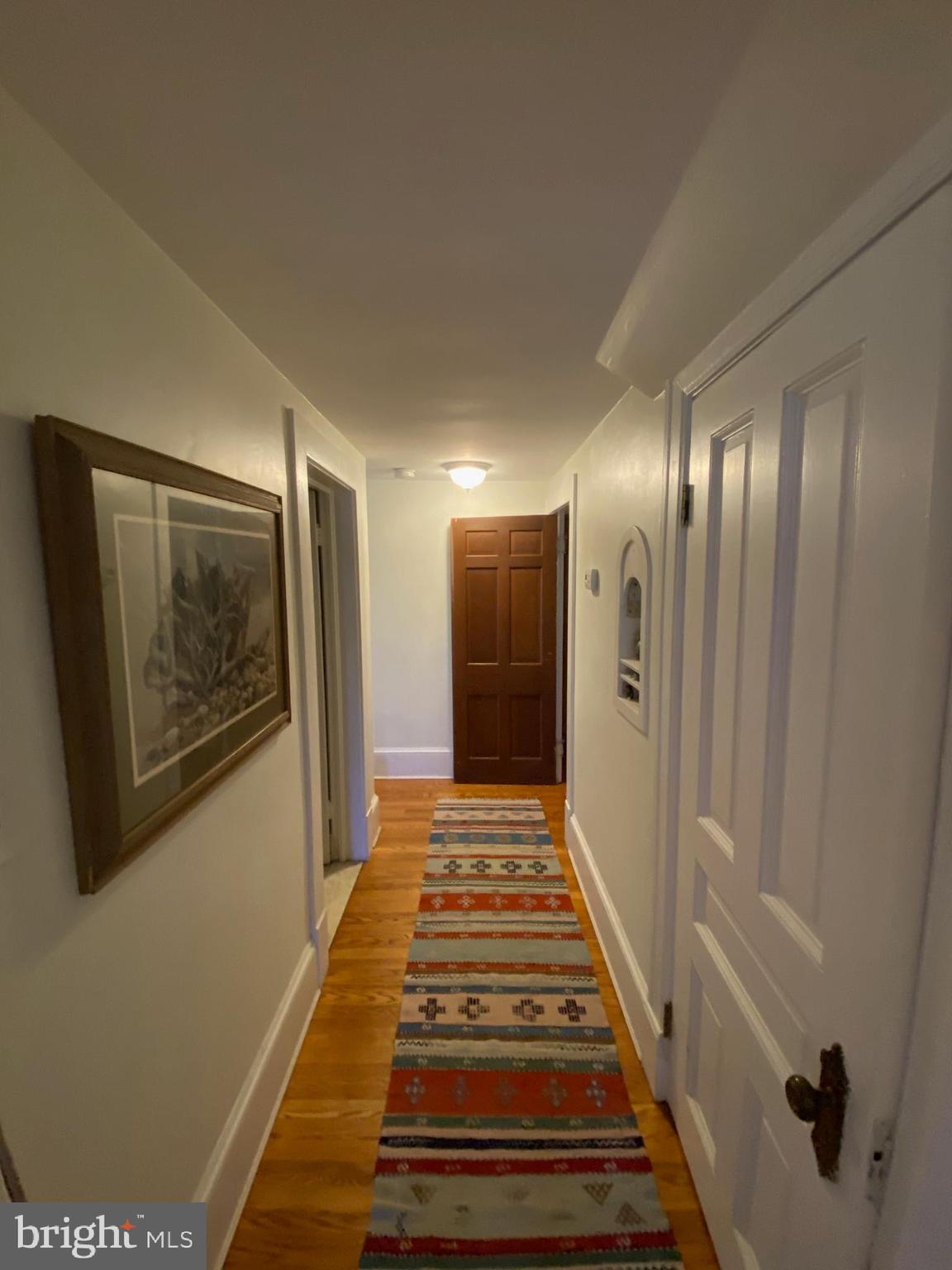 5713 Roland Avenue Baltimore, MD 21210 - Photo 17 of 29 a view of a hallway with wooden floor