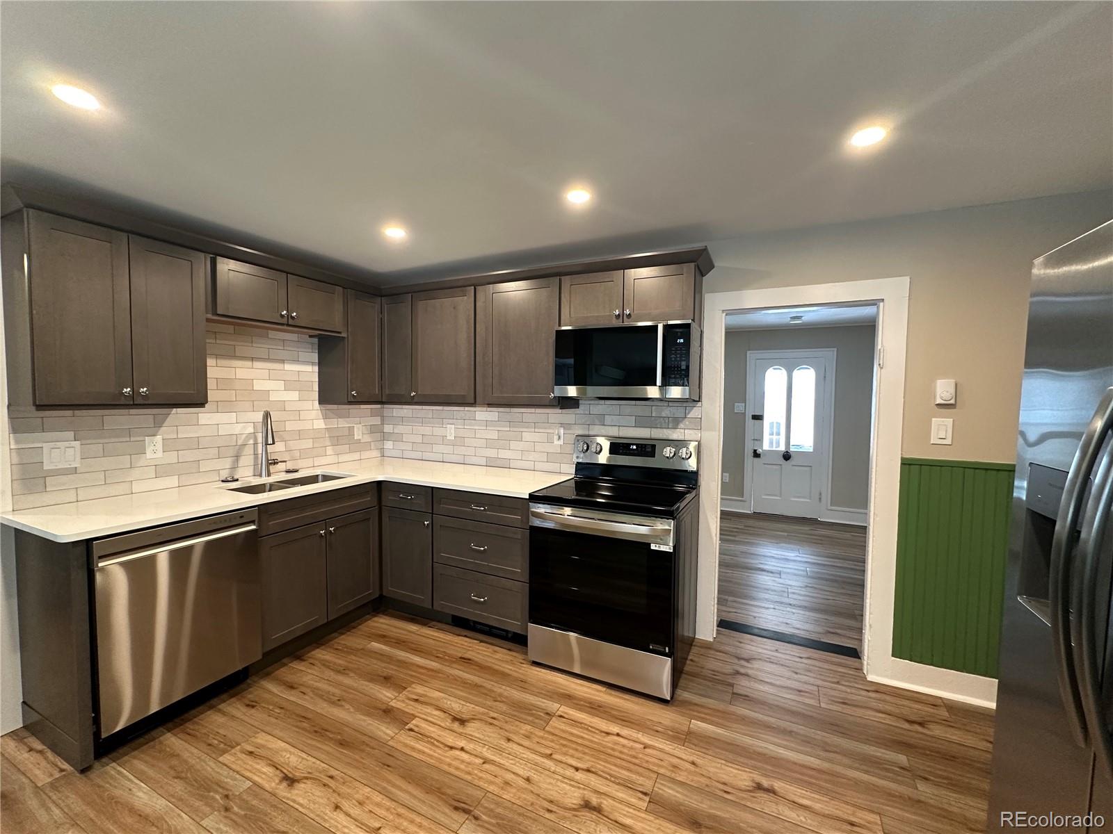 906 Main Street Georgetown, CO 80444 - Photo 12 of 28 a kitchen with granite countertop stainless steel appliances and wooden cabinets